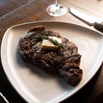 Rib eye steak served on a plate.