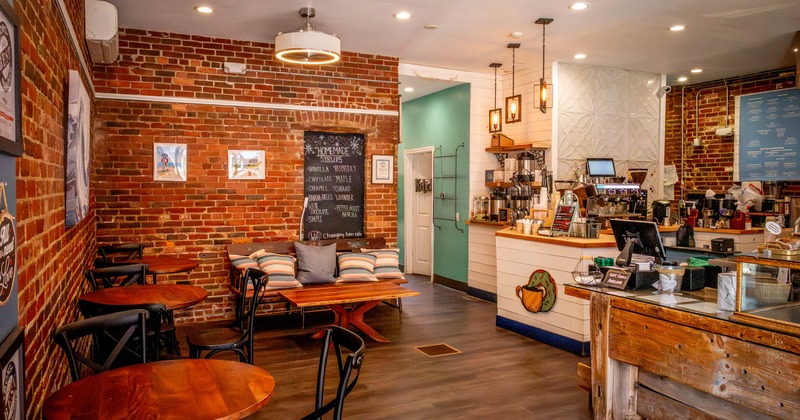 Interior, seating area, round tables with chairs, checkout counter on the right