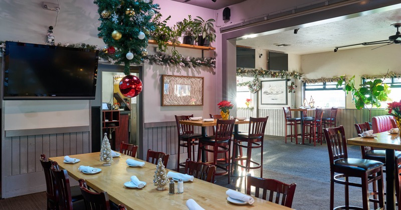 Restaurant interior with festive holiday decorations and seating arrangement
