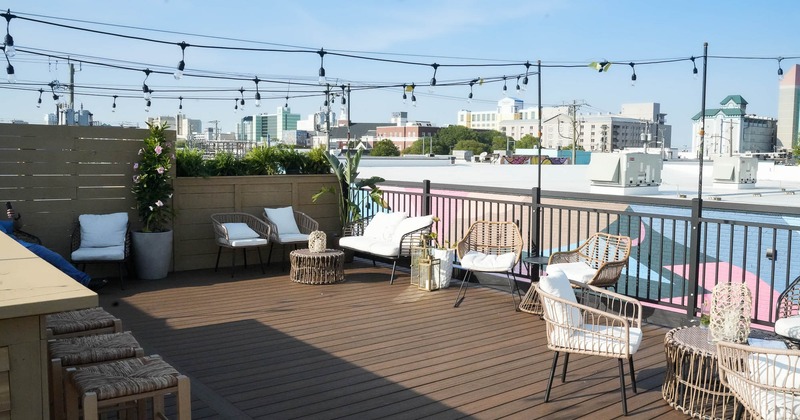 Rooftop patio with chairs and lightbulbs as a decoration