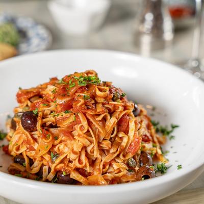 Trenette Puttanesca House Made pasta sauce of tomato, Niçoise olives, capers, onions, Red Pepper, garlic, anchovy & olive oil.