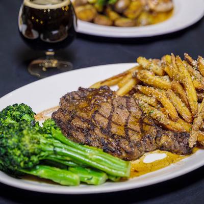 Twelve ounce rib eye, served with broccolini and truffle fries.