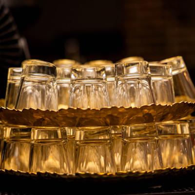 Numereus shot glasses arranged on a set of scalloped serving trays.