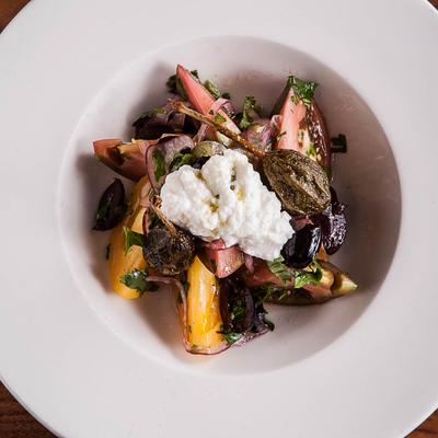 Roasted vegetables topped with soft cheese.