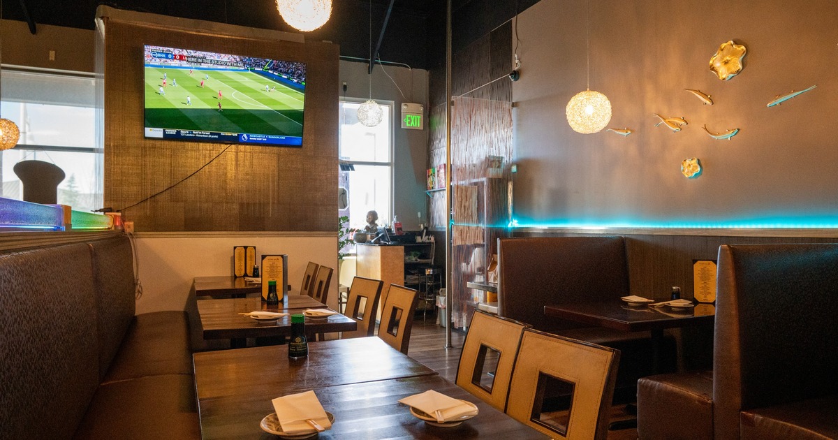 Interior, dining area with leather seats, wooden tables and chandeliers