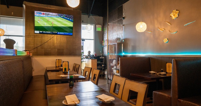 Interior, dining area with leather seats, wooden tables and chandeliers
