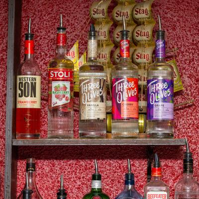 Bottles of strong drinks on shelves.