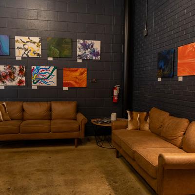 Interior, a nook with sofas and abstract paintings on walls.