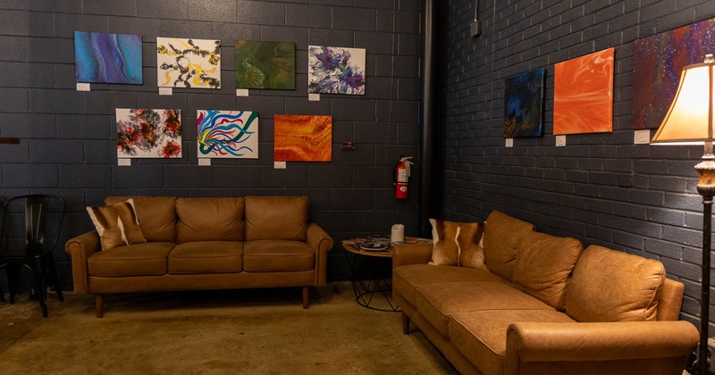 Interior, two couches near wall decorated with paintings