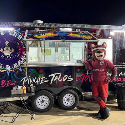 Mascot posing by the food truck.