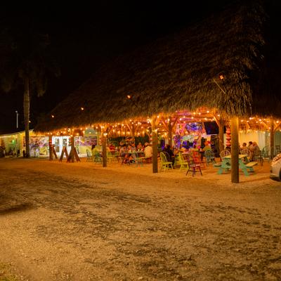 Restaurant's open-air patio with tiki-style roof.