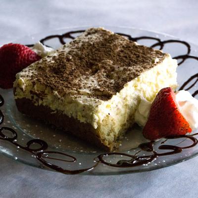 Tiramisu garnished with strawberry and cream