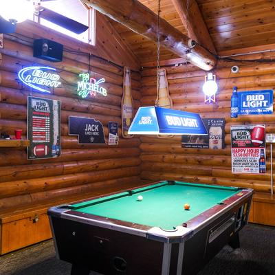 Interior, pool table, lighting, various decorations, wooden walls and ceiling
