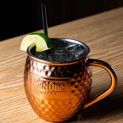 Moscow Mule in a copper mug with lime wedge.