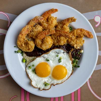 Shrimp and Grits topped with bacon gravy and two fried eggs.