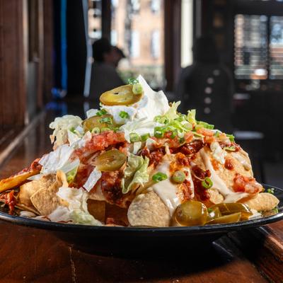 Plate of Loaded Nachos with various toppings.