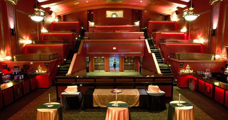 Interior, cocktail tables, multi-level theater seating behind