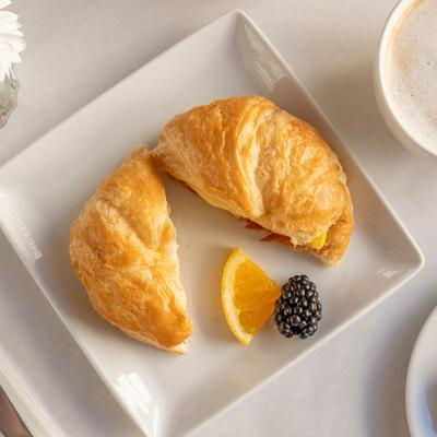 Croissant sandwich, with ham, cheese, and tomato.