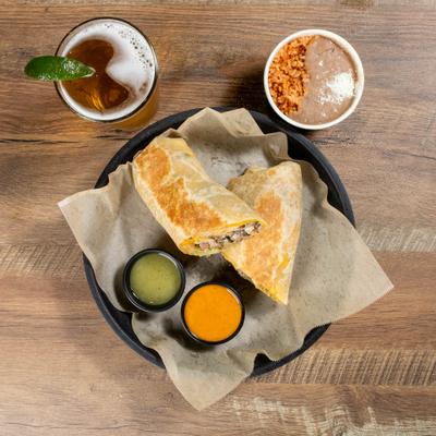 Burrito, beer beans and rice with 2 sauces photographed from abover.