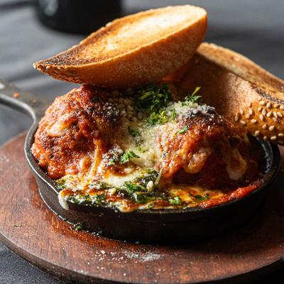 Beef Meatballs served in a skillet with grilled bread