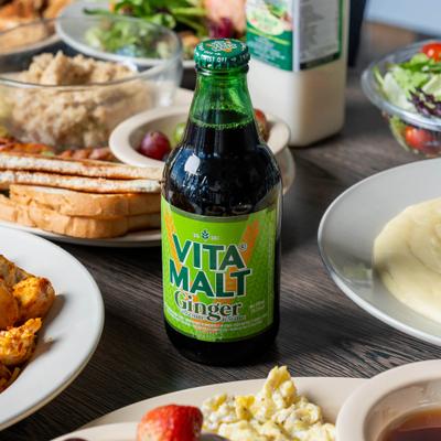 Various food and a bottle of ginger malt.