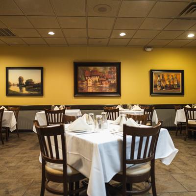 Interior, tables, chairs, paintings on walls, lights