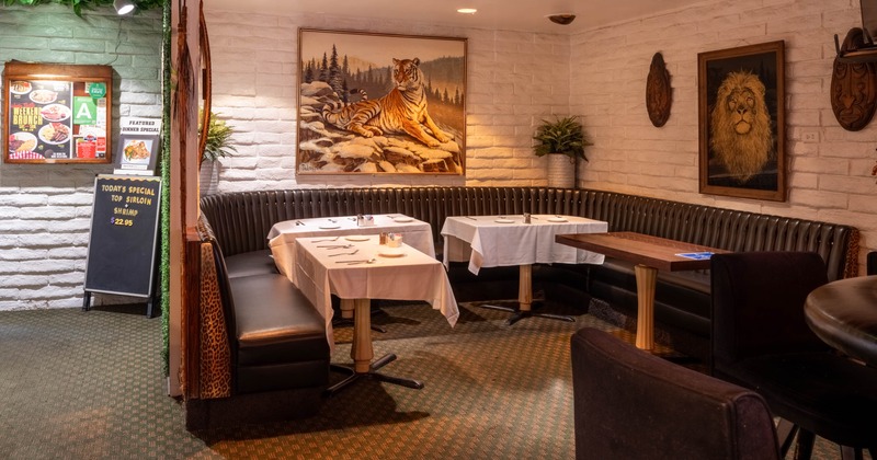 Interior, dining area, large ''U'' shaped banquette bench with four tables, carpet flooring