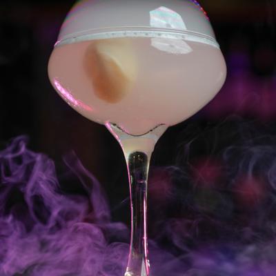 Cocktail in coupette glass garnished with smoke bubble.