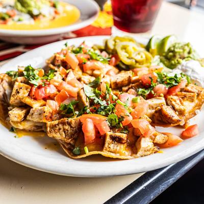 Pastor Poncho Nachos plate on a dining  table.