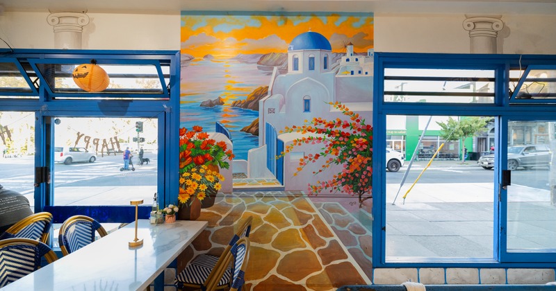 Dining room, chairs at the table, paint on the wall, windows facing the street