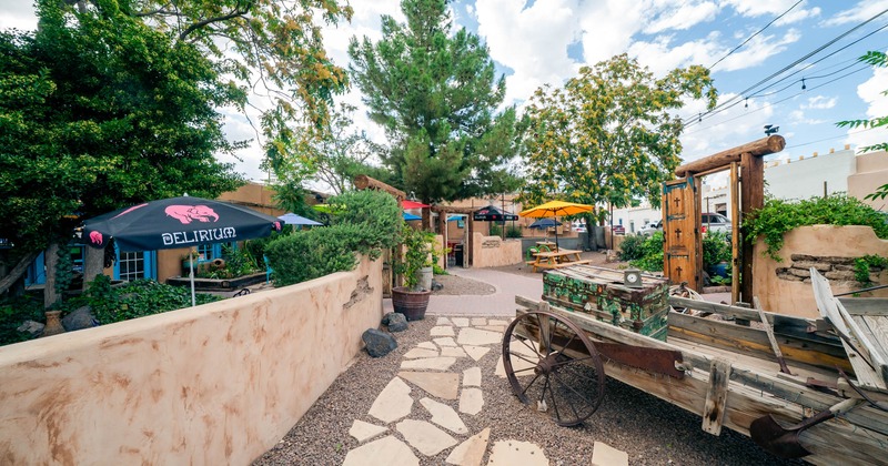 Outdoor patio with rustic decor, stone path, and umbrellas