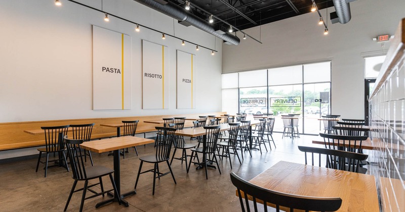 Interior with tables and chairs, windows in the back