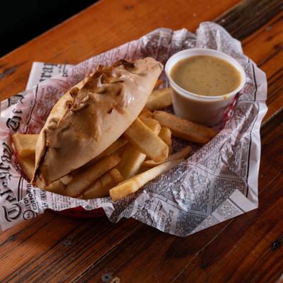 Chicken curry pasty with fries and a sauce.
