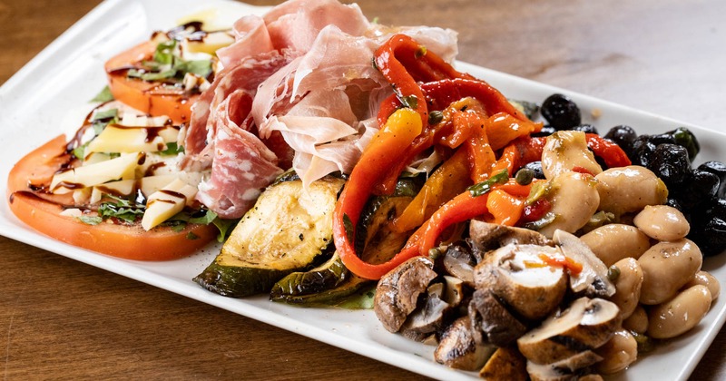 Cured Italian meats and imported cheeses with vegetables and cured olives
