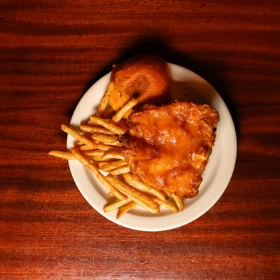 Fried Cod Fish sandwich with tartar sauce and pickles.