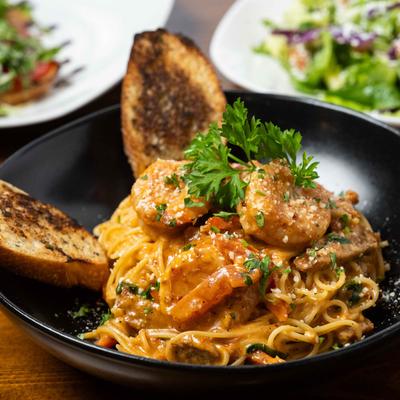 Shrimp pasta with tomato sauce and garlic bread.