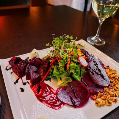 Beetroot salad with a glass of white wine.