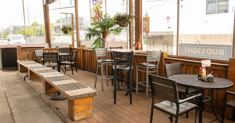 Covered porch area with tables and chairs