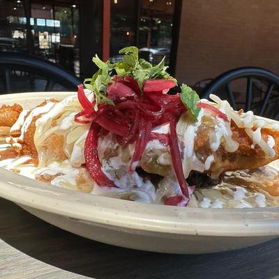 Burger smothered with green chile.