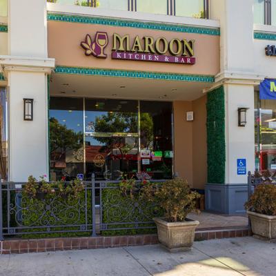 Restaurant front entrance and a fenced off patio.
