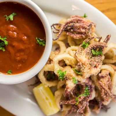 Octopus meat, onion rings and dip on the side