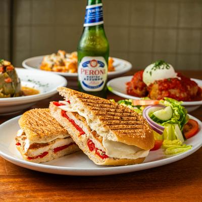 Chicken and Mozzarella panini served with meatballs, pasta, and a beer.