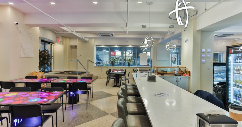 Interior, a bar on the right with tables and chairs on the left