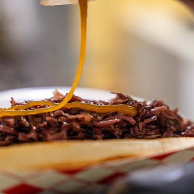 Grilled smoked kielbasa sandwich, with sweet and sour red cabbage, bacon, and honey mustard.