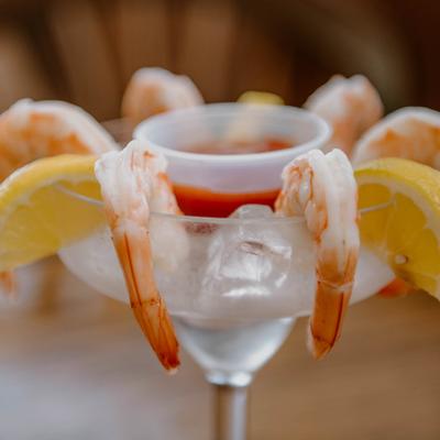 Jumbo shrimp cocktail served with lemon slices and cocktail sauce.