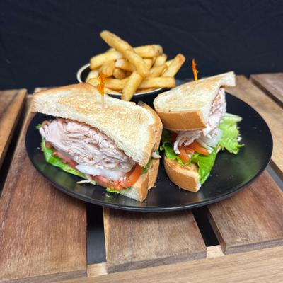 Turkey sandwich with French fries.