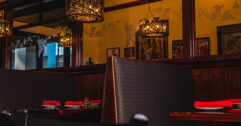 Booths with tableware and napkins on tables