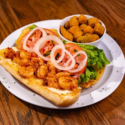 Po boy shrimp sandwich with fried okra on the side.