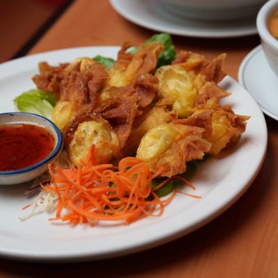 Crab Wontons with a dipping sauce on the side.