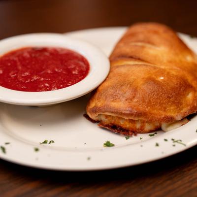 Calzone, with marinara sauce.